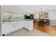 Open concept kitchen with white cabinets flows into living and dining areas, great for entertaining at 3329 Winnipeg Cir, Charlotte, NC 28210