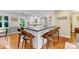 Bright, modern kitchen with a breakfast bar featuring white cabinets and wood-seated barstools at 3329 Winnipeg Cir, Charlotte, NC 28210