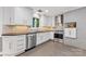 Updated kitchen boasts stainless steel appliances, white cabinetry, and stylish backsplash tile at 3329 Winnipeg Cir, Charlotte, NC 28210