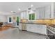 Well-lit kitchen featuring stainless steel appliances, white cabinets, and a door to the backyard at 3329 Winnipeg Cir, Charlotte, NC 28210