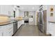 Bright kitchen showcasing stainless steel appliances, crisp white cabinetry, and modern backsplash tile at 3329 Winnipeg Cir, Charlotte, NC 28210
