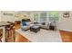 Living room featuring large windows, hard wood floors and stylish furniture at 3329 Winnipeg Cir, Charlotte, NC 28210
