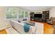 Bright living room featuring large windows, stylish furniture, and built-in bookshelves at 3329 Winnipeg Cir, Charlotte, NC 28210