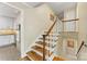 Staircase with wood steps and white railings connects different levels of the home at 3329 Winnipeg Cir, Charlotte, NC 28210