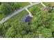 Aerial view of a brick home surrounded by lush greenery at 3398 Millstone Creek Rd, Lancaster, SC 29720