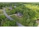 Stunning aerial view of a home with a well-manicured lawn surrounded by lush greenery and mature trees at 3398 Millstone Creek Rd, Lancaster, SC 29720