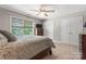 Bedroom with ceiling fan, carpet, large window with shade and double doors to the closet at 3398 Millstone Creek Rd, Lancaster, SC 29720