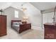 Vaulted ceiling bedroom includes a ceiling fan, window, and a coordinated dark wood furniture set at 3398 Millstone Creek Rd, Lancaster, SC 29720