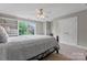 Cozy bedroom with a white ceiling fan and built-in shelves next to the window at 3398 Millstone Creek Rd, Lancaster, SC 29720