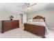 Bedroom with wood dresser, ornate wood bedframe, soft carpeting, and ceiling fan at 3398 Millstone Creek Rd, Lancaster, SC 29720