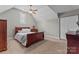 Cozy bedroom with neutral walls, soft carpet, and a classic wooden bed frame at 3398 Millstone Creek Rd, Lancaster, SC 29720