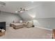 Spacious bonus room featuring a comfortable sectional sofa and plush carpeting at 3398 Millstone Creek Rd, Lancaster, SC 29720