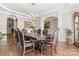 Elegant dining room with hardwood floors, chandelier, and arched doorways offering a warm, inviting ambiance at 3398 Millstone Creek Rd, Lancaster, SC 29720