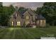 Charming brick home featuring manicured landscaping and an inviting front entrance at dusk at 3398 Millstone Creek Rd, Lancaster, SC 29720