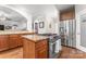 Open kitchen with stainless steel refrigerator, cooktop island, and walk-in pantry at 3398 Millstone Creek Rd, Lancaster, SC 29720