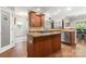 Open kitchen with a center island, granite countertops, stainless steel appliances, and hardwood floors at 3398 Millstone Creek Rd, Lancaster, SC 29720