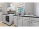 Bright laundry room featuring a front loading washer, ample counter space, and built in storage at 3398 Millstone Creek Rd, Lancaster, SC 29720