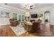 Inviting living room with hardwood floors, coffered ceiling, and french doors offering natural light and space at 3398 Millstone Creek Rd, Lancaster, SC 29720