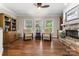 Inviting living room with hardwood floors, stone fireplace, and natural light at 3398 Millstone Creek Rd, Lancaster, SC 29720