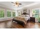 Spacious main bedroom boasts tray ceiling, large windows, and rich hardwood flooring at 3398 Millstone Creek Rd, Lancaster, SC 29720