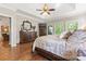 This spacious main bedroom has hardwood floors, tray ceiling, and multiple windows for natural light at 3398 Millstone Creek Rd, Lancaster, SC 29720
