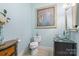 Stylish powder room with a modern vanity, glass bowl sink, and chic decor at 3398 Millstone Creek Rd, Lancaster, SC 29720
