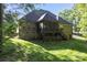 A brick home showcasing a screened-in porch and well-maintained backyard at 3398 Millstone Creek Rd, Lancaster, SC 29720