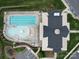 Aerial view of a community pool with lounge chairs, umbrellas, and landscaped surroundings at 4027 Gozzi Dr, Iron Station, NC 28080