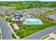 Aerial view of a community pool area with a clubhouse, lounge chairs, and manicured landscaping at 4027 Gozzi Dr, Iron Station, NC 28080