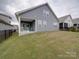 A backyard featuring a well-maintained lawn and a covered patio, perfect for outdoor activities at 4027 Gozzi Dr, Iron Station, NC 28080