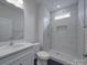 Modern bathroom with a tiled shower, a vanity, and stylish fixtures at 4027 Gozzi Dr, Iron Station, NC 28080