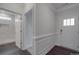 Hallway leading to a bathroom, featuring wainscoting detail and dark wood floors at 4027 Gozzi Dr, Iron Station, NC 28080