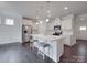 Modern kitchen with stainless steel appliances, white cabinetry, and an island with seating at 4027 Gozzi Dr, Iron Station, NC 28080