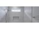 Close-up of a stylish tiled shower with a built-in niche and rainfall shower head at 4027 Gozzi Dr, Iron Station, NC 28080