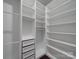 A walk-in closet featuring custom white shelving, drawers, and ample storage space at 4027 Gozzi Dr, Iron Station, NC 28080