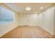 Finished basement featuring a large window, recessed lighting, and new floors at 405 Belva St, Kannapolis, NC 28081