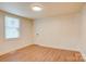 Bedroom featuring neutral paint, wood laminate flooring, and natural light from the window at 405 Belva St, Kannapolis, NC 28081