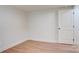 Bedroom featuring neutral paint, wood laminate flooring, base trim and interior door at 405 Belva St, Kannapolis, NC 28081