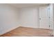 Bedroom featuring neutral paint, wood laminate flooring, base trim and interior door at 405 Belva St, Kannapolis, NC 28081