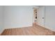 Bedroom featuring neutral paint, wood laminate flooring, base trim and interior door at 405 Belva St, Kannapolis, NC 28081