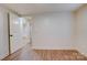 Bedroom featuring neutral paint, wood laminate flooring, base trim and interior door at 405 Belva St, Kannapolis, NC 28081
