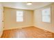 Bedroom featuring neutral paint, wood laminate flooring, and natural light from the window at 405 Belva St, Kannapolis, NC 28081