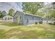 Charming blue home features a bright yellow door and well-manicured lawn at 405 Belva St, Kannapolis, NC 28081