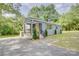 Charming blue house with wooden accents, covered porch, and well-maintained landscaping at 405 Belva St, Kannapolis, NC 28081