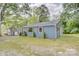 Charming blue house featuring wooden shutters, lush lawn and mature trees at 405 Belva St, Kannapolis, NC 28081