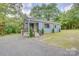 Charming blue single-Gathering home featuring a gravel driveway and inviting front porch at 405 Belva St, Kannapolis, NC 28081