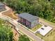 Aerial view of new townhomes with green space, parking, and community pond at 411 Old Town Village Rd, Waxhaw, NC 28173