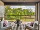 Relaxing balcony setting with comfortable seating, ceiling fan, and serene outdoor views at 411 Old Town Village Rd, Waxhaw, NC 28173