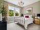 Inviting bedroom with large windows, neutral tones and a comfortable bed at 411 Old Town Village Rd, Waxhaw, NC 28173