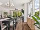Open-concept dining area with hardwood floors, stylish decor, and seamless transition to the living room and outdoors at 411 Old Town Village Rd, Waxhaw, NC 28173